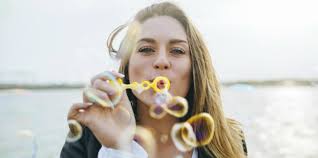 girl blowing bubbles