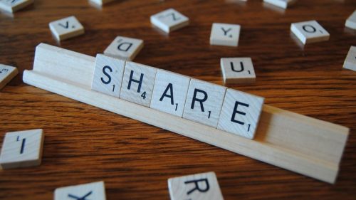 share written with scrabble tiles