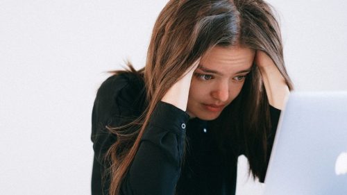 a stressed girl with her laptop