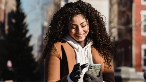 single and happy girl seeing her mobile