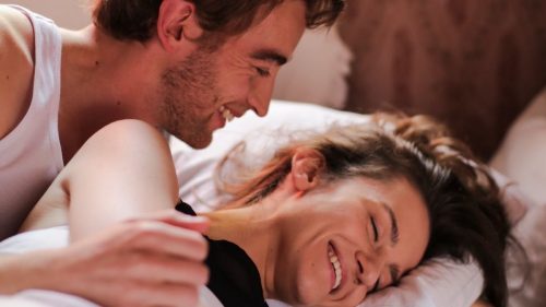 playful couple in the bed