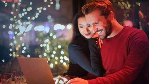 a happy guy sitting with a girl