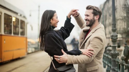 a happy couple holding hands and smiling