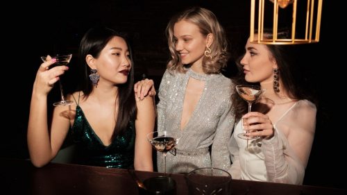 three girls holding their drinks