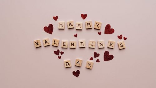 happy valentines day text on pink surface