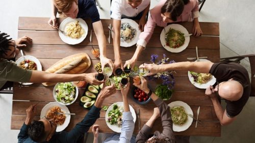 group of people enjoying dinner on a table