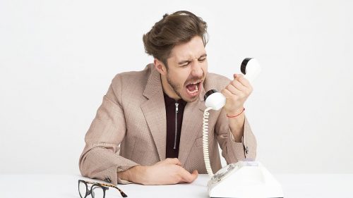 a man shouting on the telephone