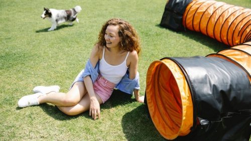 girl sitting in a garden with her pet