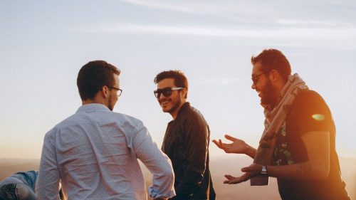 three young men talking