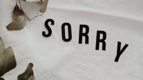 paper with the word sorry printed on it