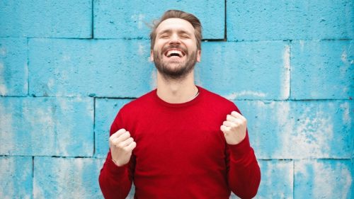 man cheering on his success